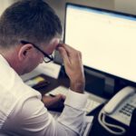Healthcare professional working at a computer in a hospital