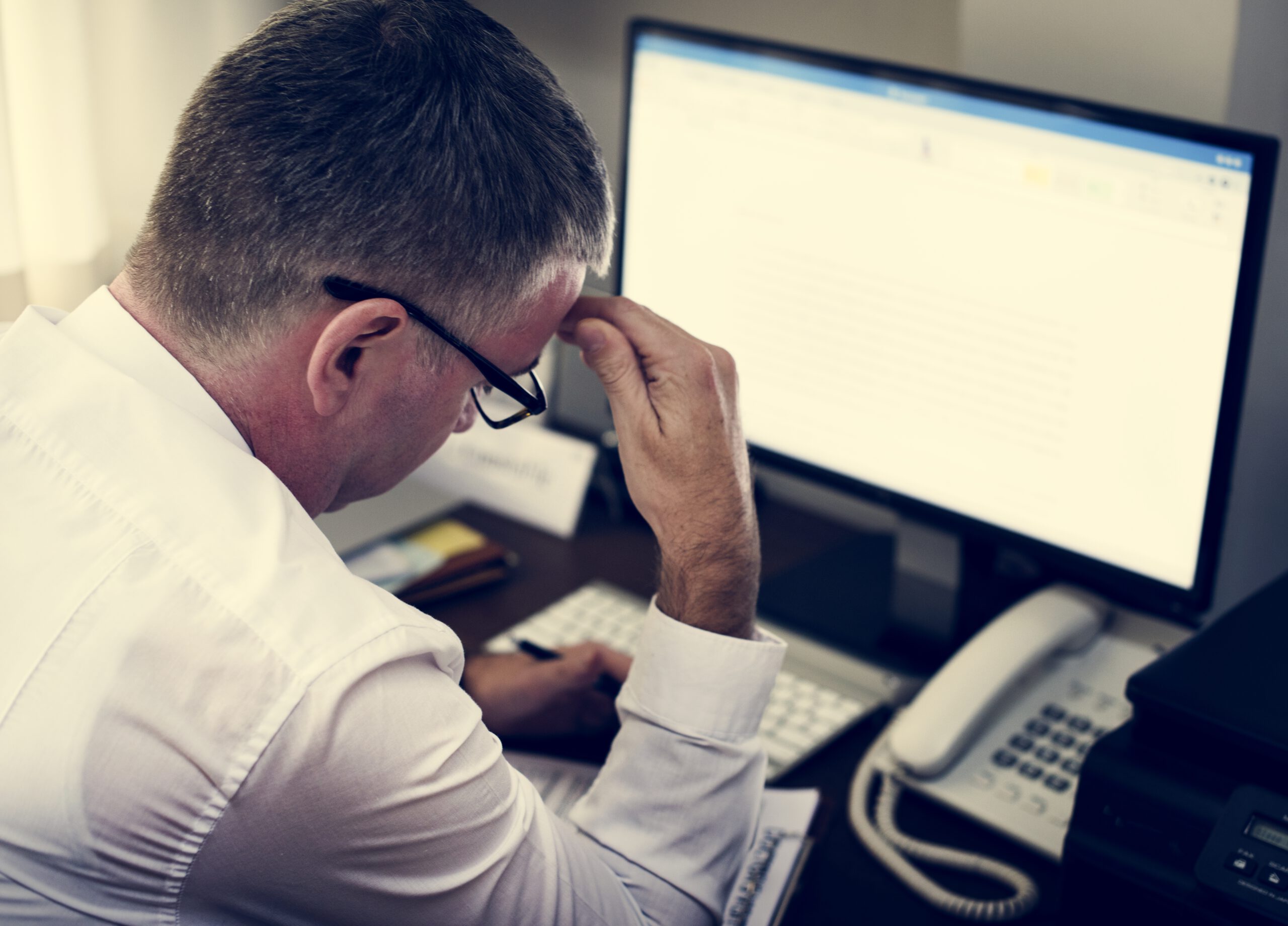 Healthcare professional working at a computer in a hospital