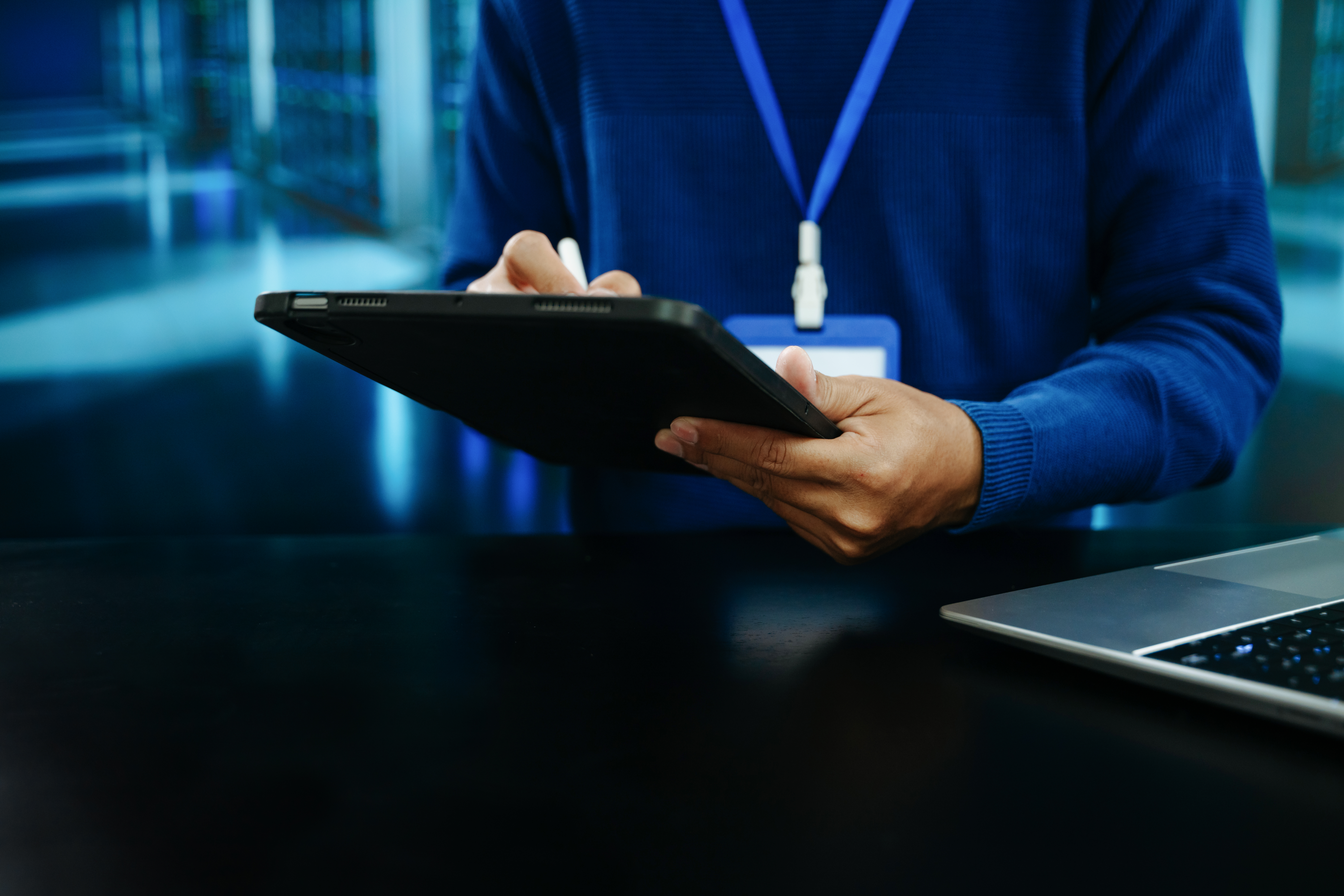 IT professional using a stylus on a laptop