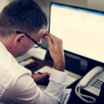 Healthcare professional working at a computer in a hospital
