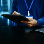 IT professional using a stylus on a laptop